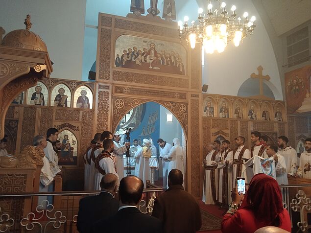 Worshippers in front of the iconostasis during a Coptic Orthodox service in their cathedral.
